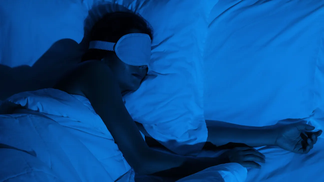 A young woman sleeping on a white bed after taking magnesium supplements