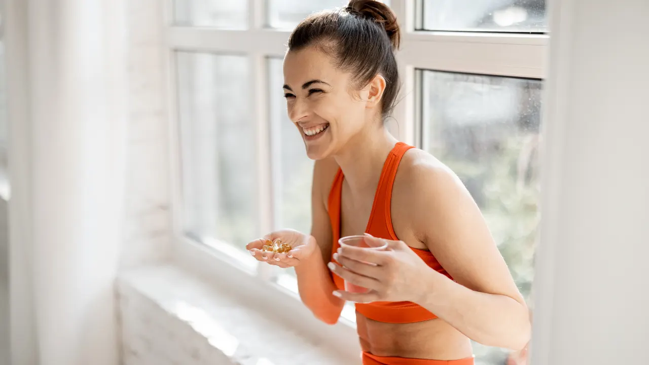 Fitness girl taking nutritional supplement