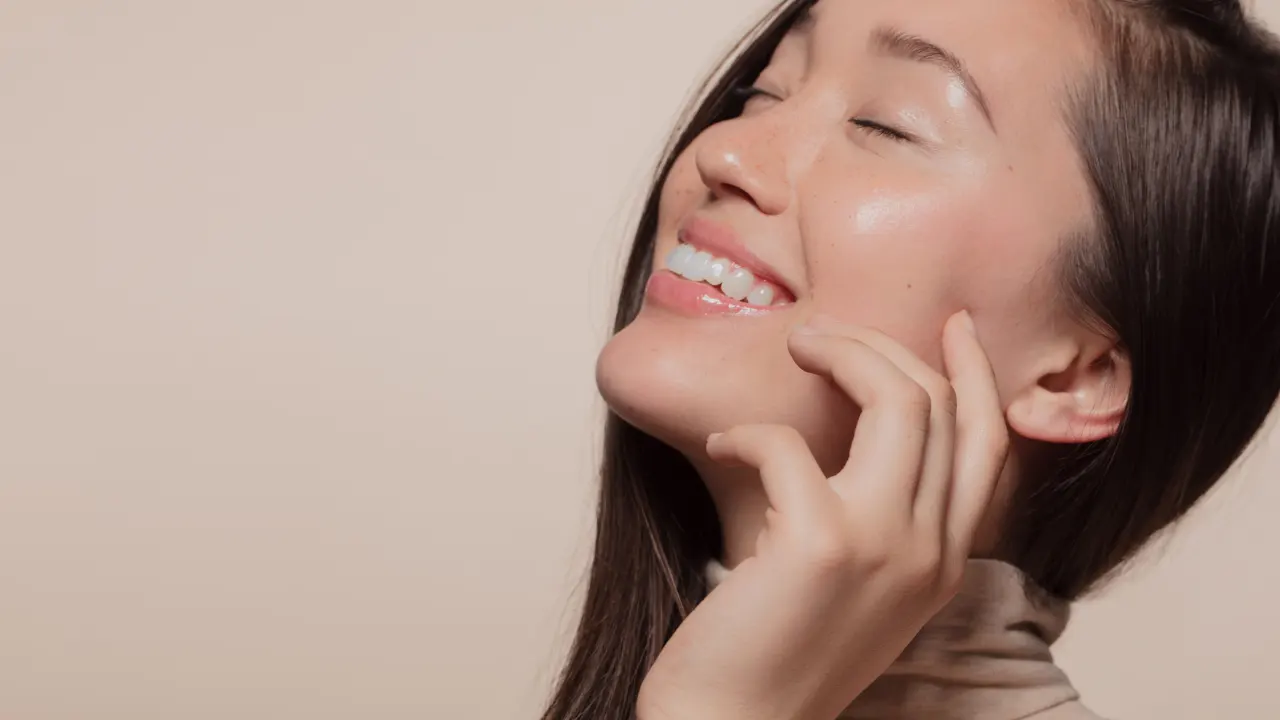 Happy young girl with healthy clear & glowing skin